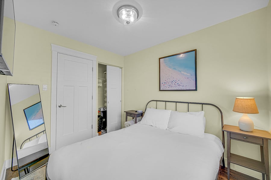 Guest Bedroom 1, with queen bed and smart TV.
