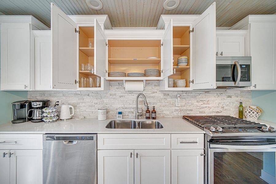 Kitchen stocked with dishware and glasses.