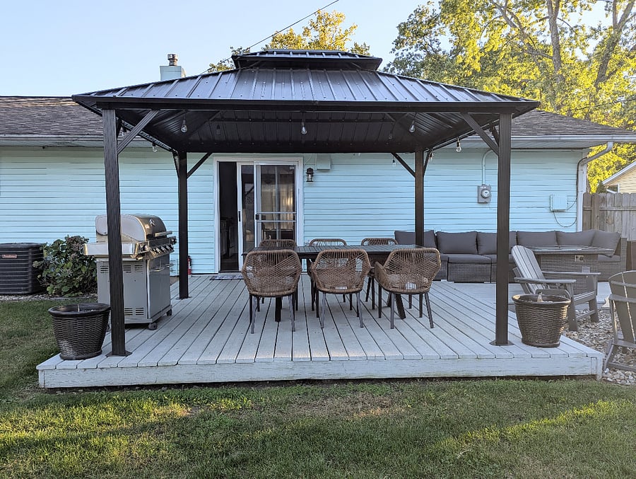 Spacious back porch with grill and outdoor dining perfect for gathering