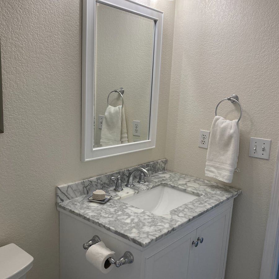 Primary bathroom has a full bath and updated vanity.