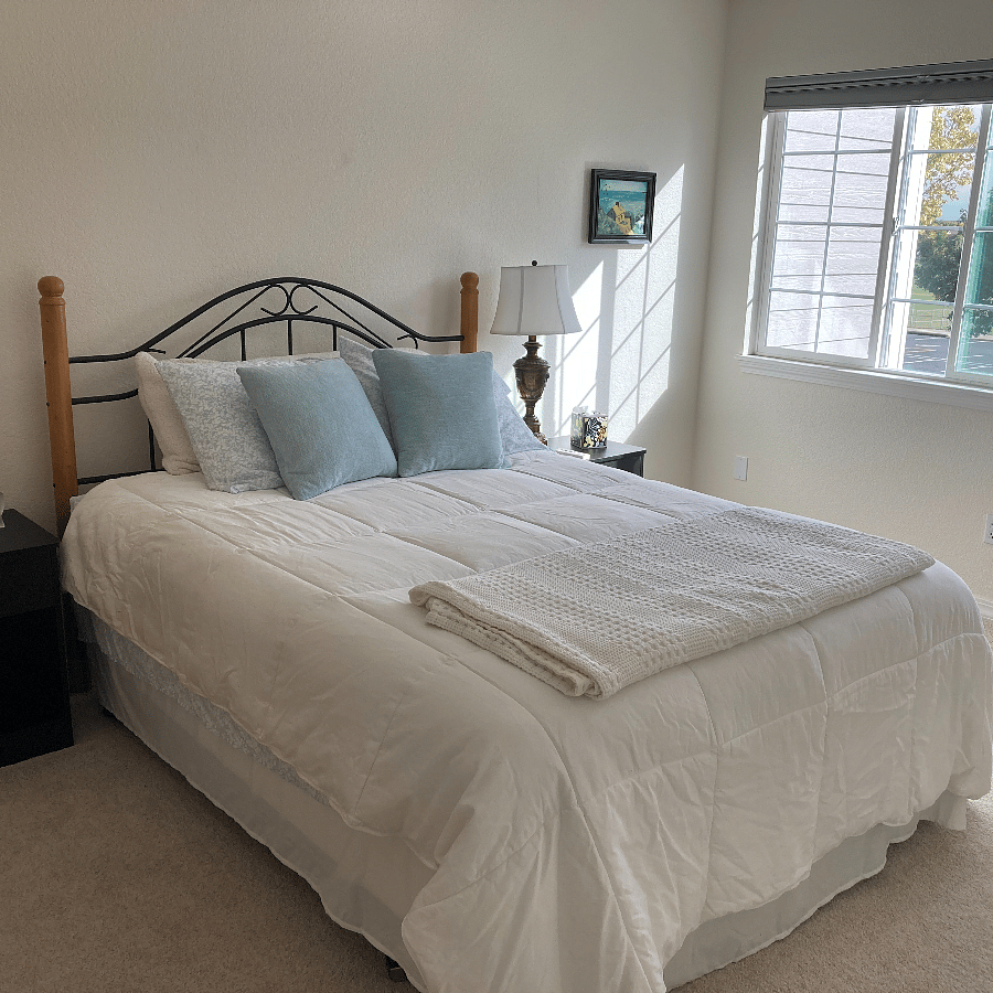 Primary bedroom has a comfortable queen bed, dresser and 2 nightstands.