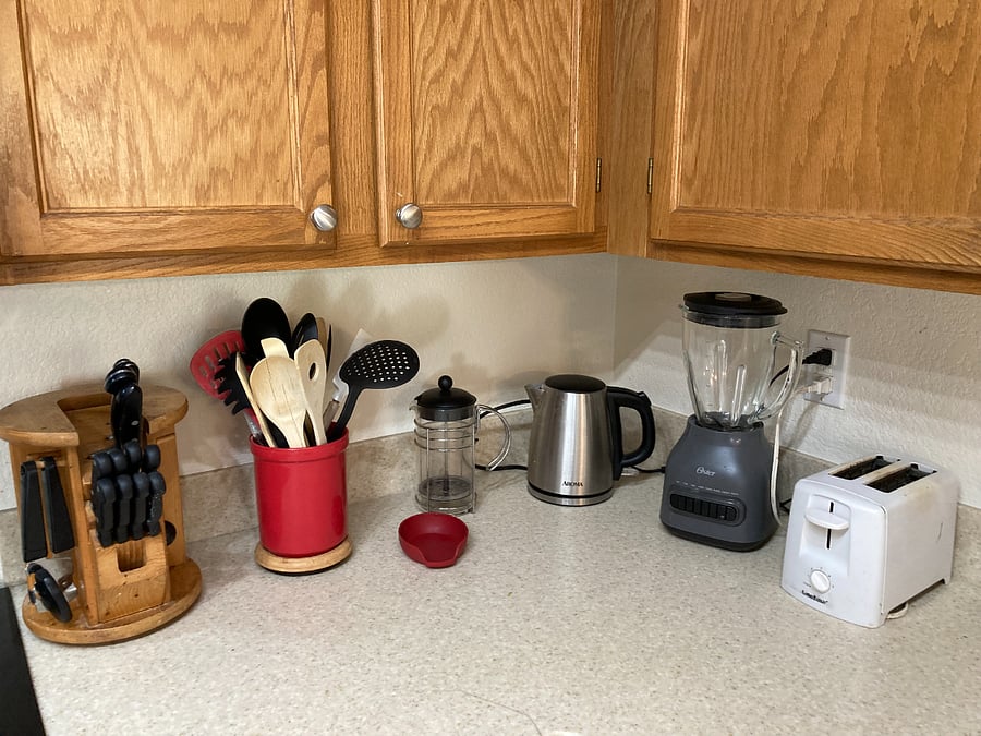Kitchen is fully stocked with appliances and cookware.