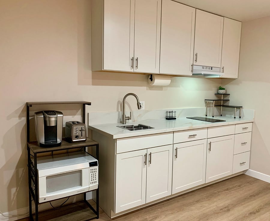 Modern, functional kitchen cabinets stocked with dishes and small appliancesstylish and practical for everyday cooking and dining.