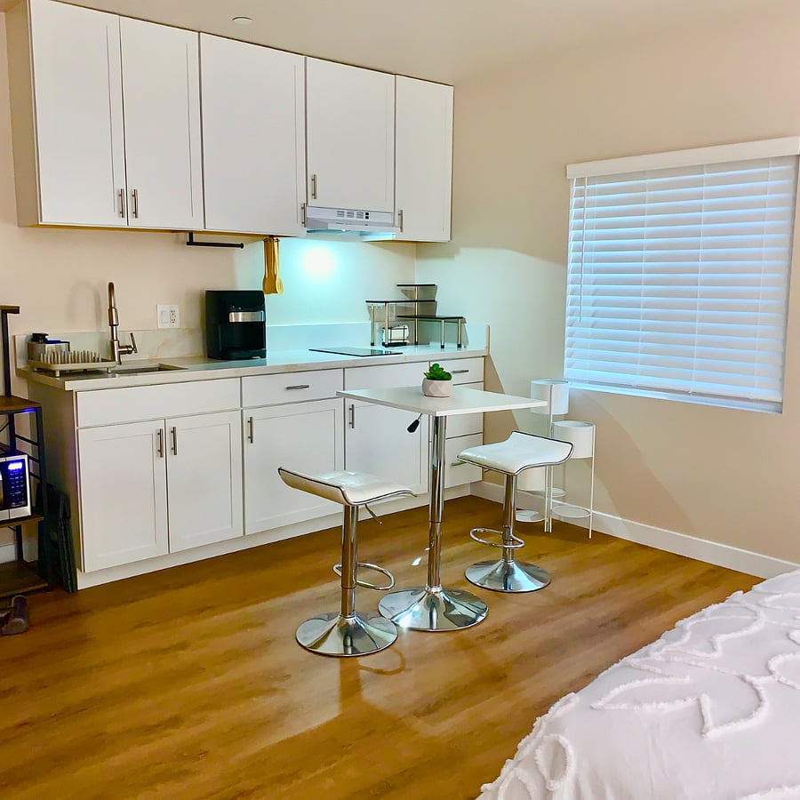 Cozy dining area with table and seating conveniently located next to the meal prep spaceideal for enjoying meals, working, or relaxing while staying connected to the heart of the kitchen.