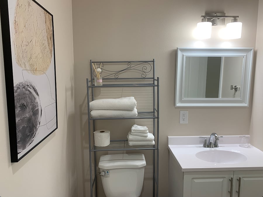 Full private bathroom stocked with fresh towels and essential toiletries, offering comfort and convenience for a relaxing and refreshing stay.