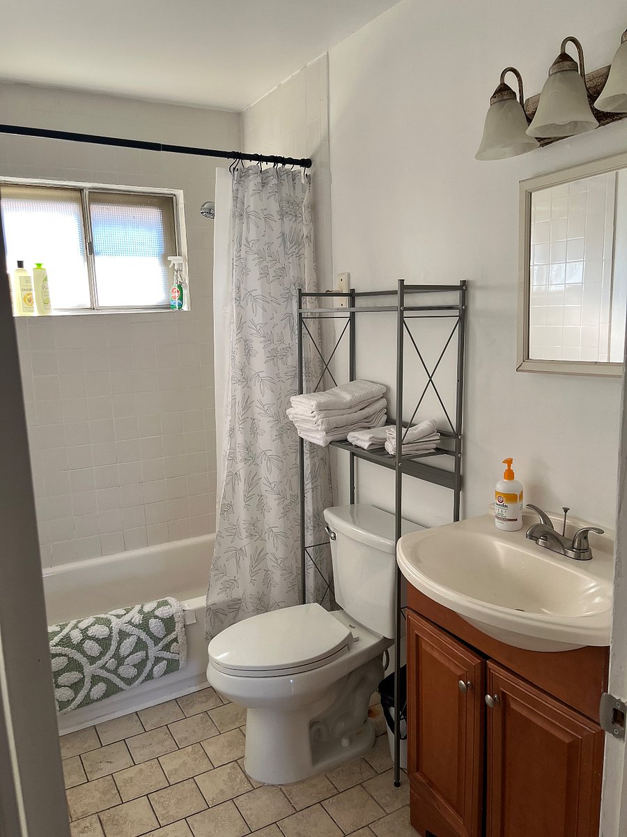 Shared bathroom with east facing exterior window.  Ample lighting, outfitted with linens, and starter shampoo, conditioner, body wash, and cleaning supplies