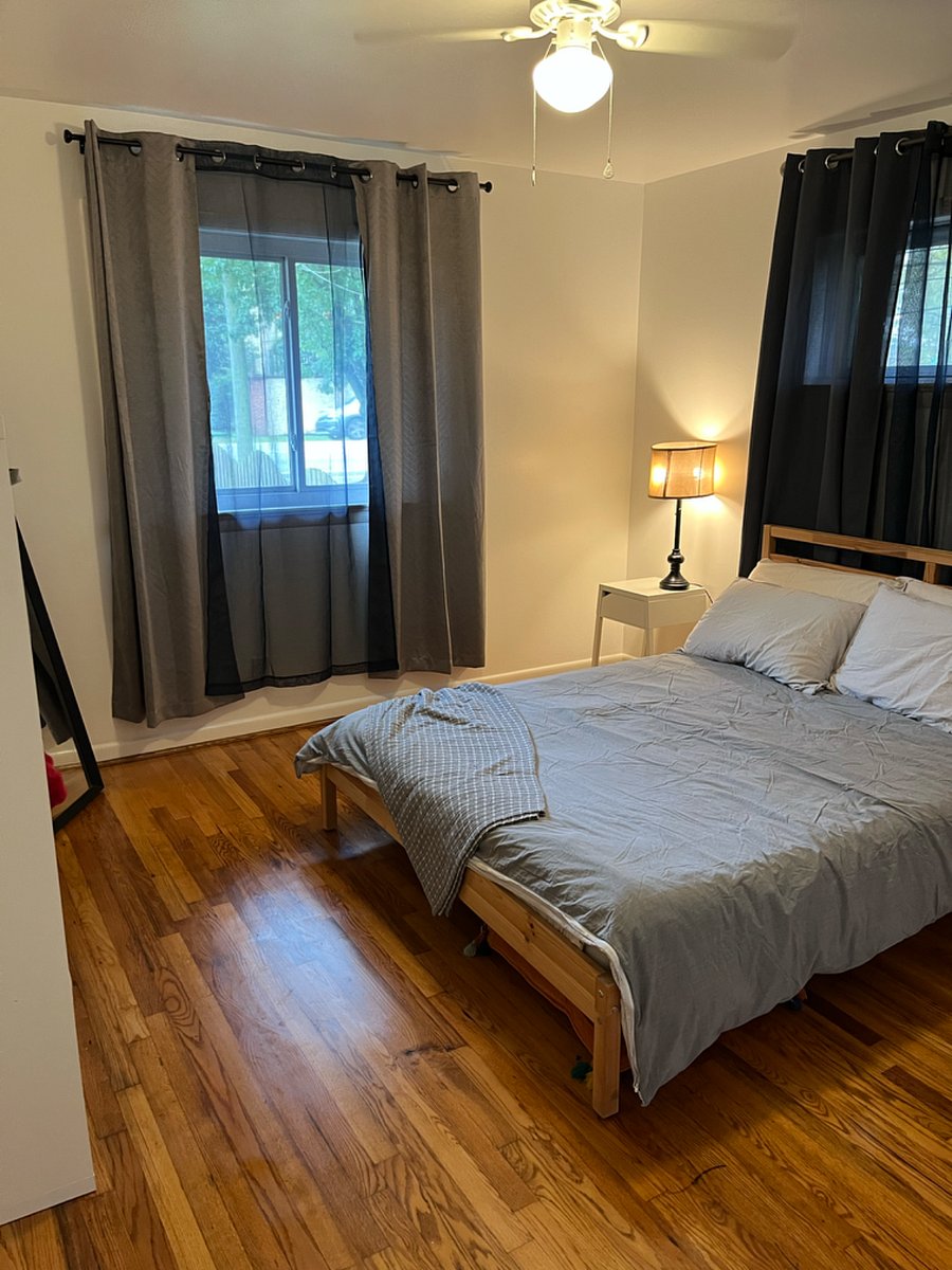 Bedroom #1. Outfitted with queen sized bed, pillows, sheets, cube shelving (utilized as a dresser), nightstand, and closet.  Located on the east 