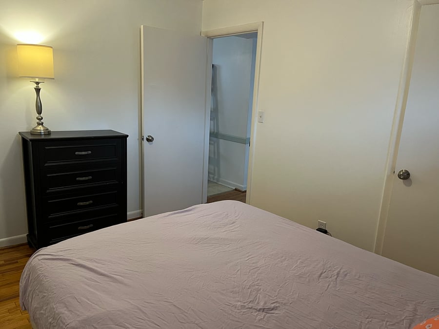 Bedroom #2.  Outfitted with queen sized bed, pillows, sheets, storage baskets under bed, nightstand, dresser and closet.  Located on the south side of the property.  