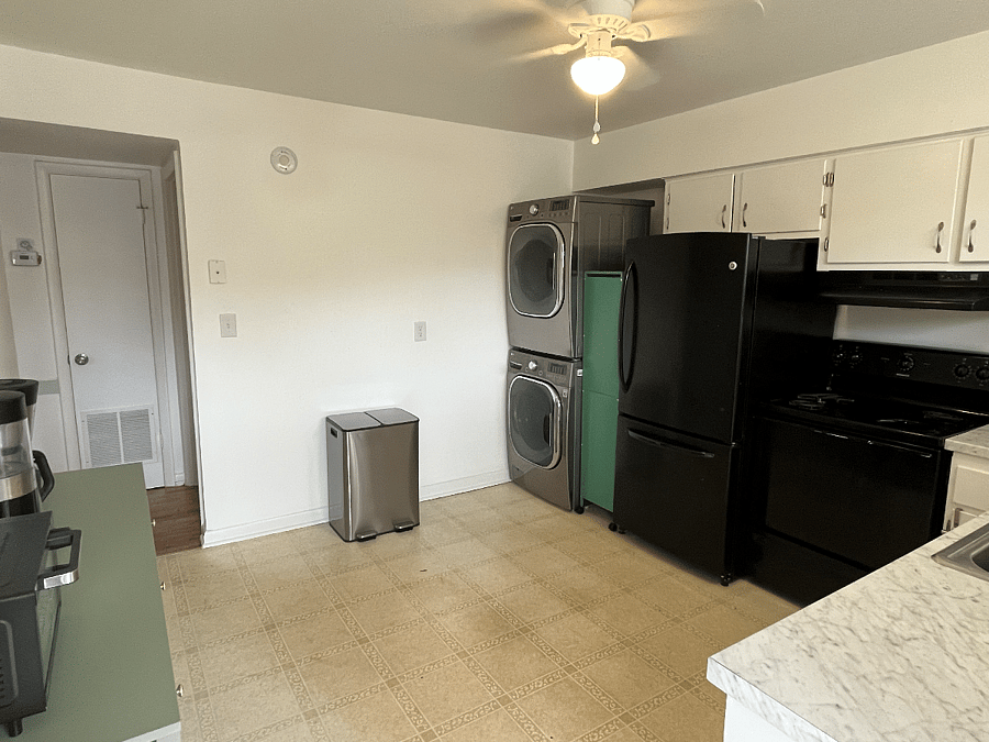 Kitchen operation across from breakfast pantry.  Outfitted with cooktop and oven, full refrigerator, and a full washer and dryer. 