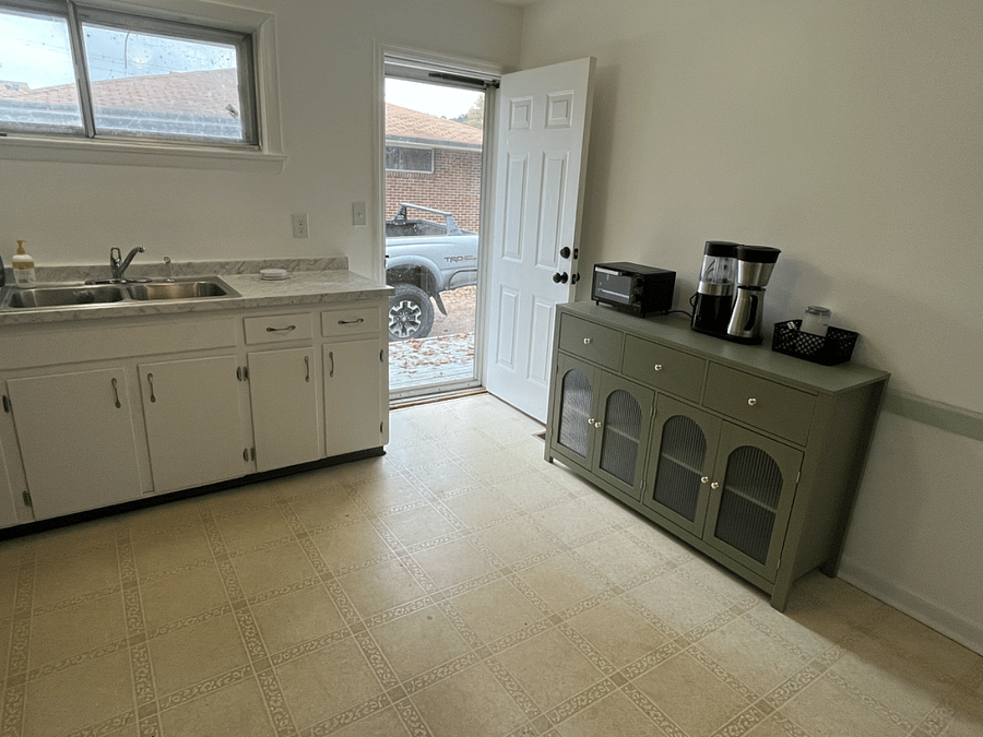 Kitchen door, breakfast nook, and pantry. Outfitted with toaster oven, coffee pot, grinder, and silverware. 
