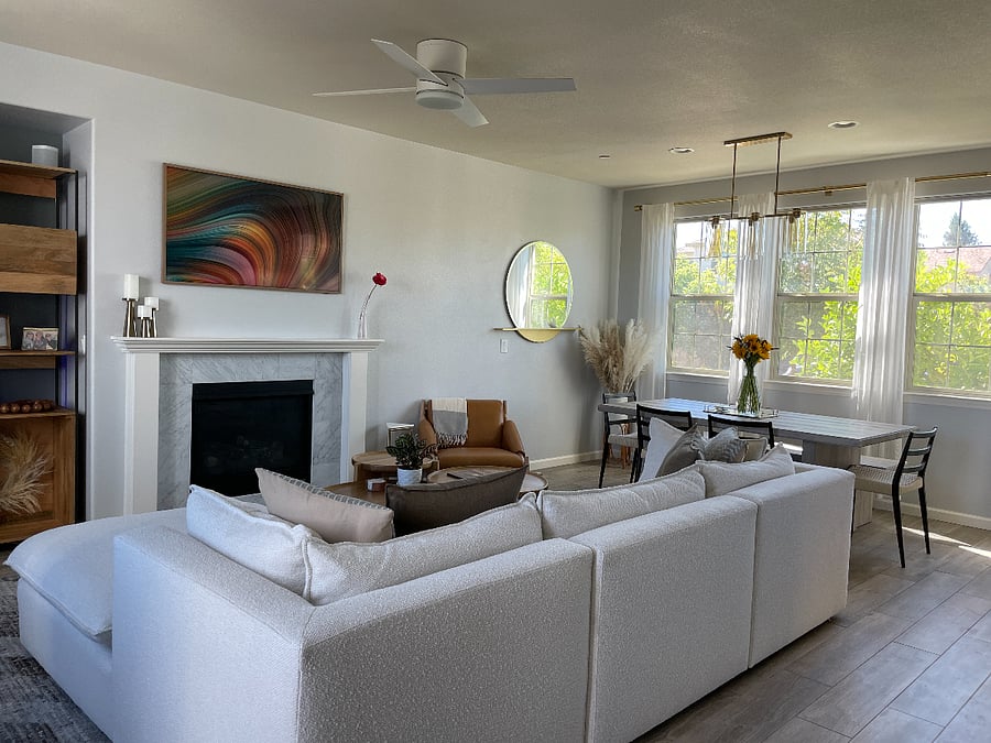 Open-concept living and dining area with large windows and a clean, modern layout.