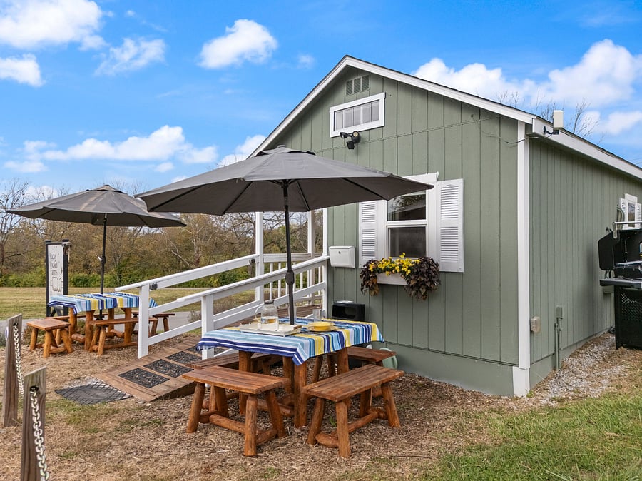 Picnic table umbrellas for sunny days along with colorful tablecloths