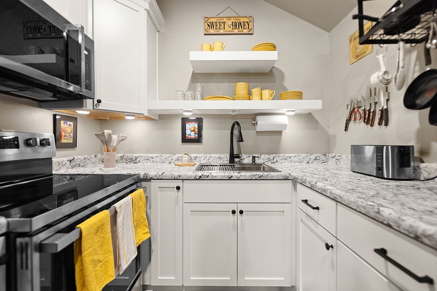 Bright kitchen has all new everything!  Chef-quality knives and T-Fal cookware makes preparing meals fun.  Full-sized fridge w filtered water and ice maker.