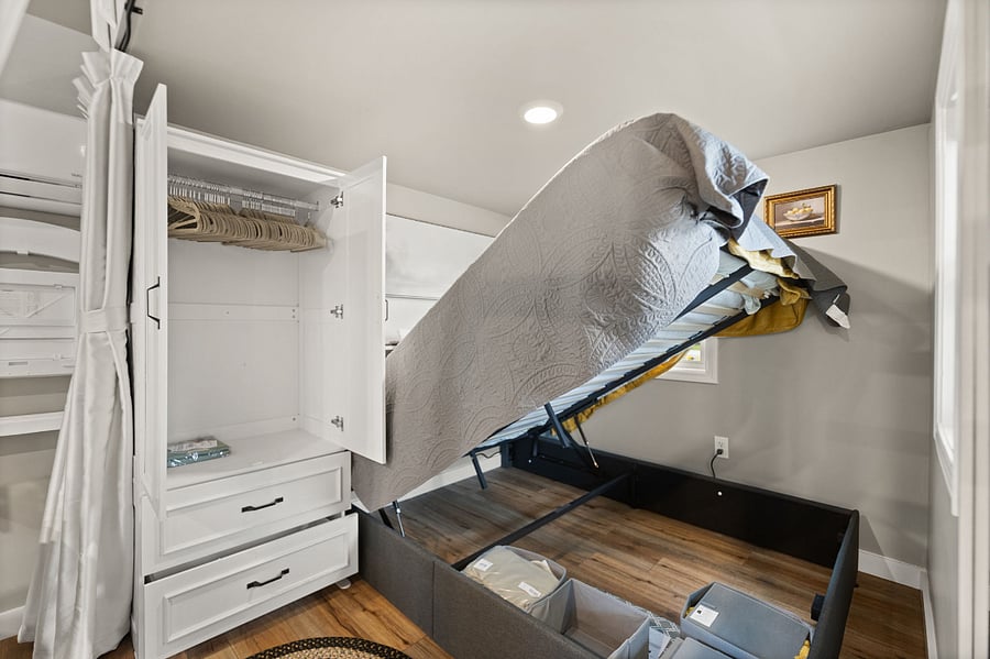 Specialized under-bed storage works on hydraulic lifts.  Armoire has hanging space and drawers.