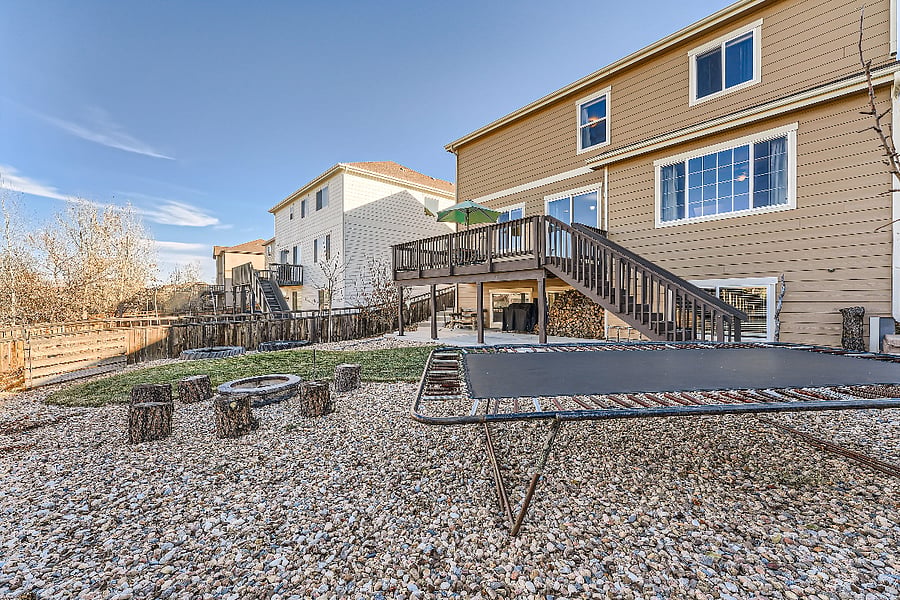 Large backyard with trampoline