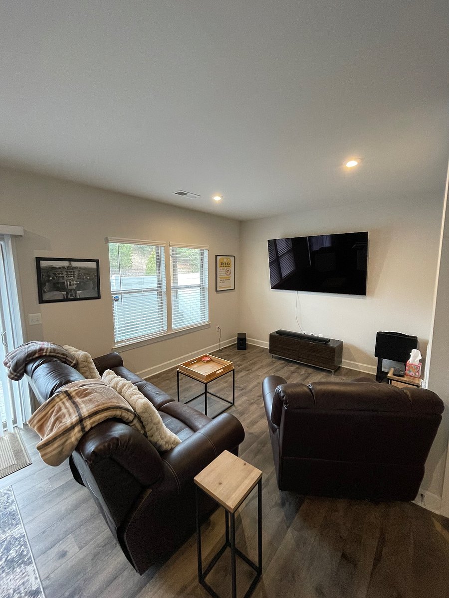 Private sitting area with 3 recliners, 77 inch LG OLED TV and Bose surround sound.