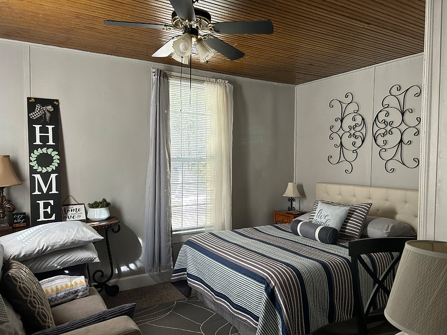 Back ( rear ) bedroom. View of back yard. Secluded. Black out drapes. Full size bed
