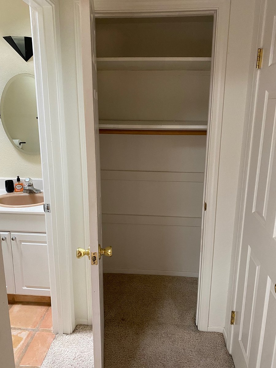 One of the hallway closets with shelving & hang space