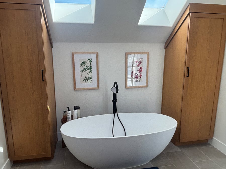 Soaking tub with ample closet space on either side for hanging clothes
