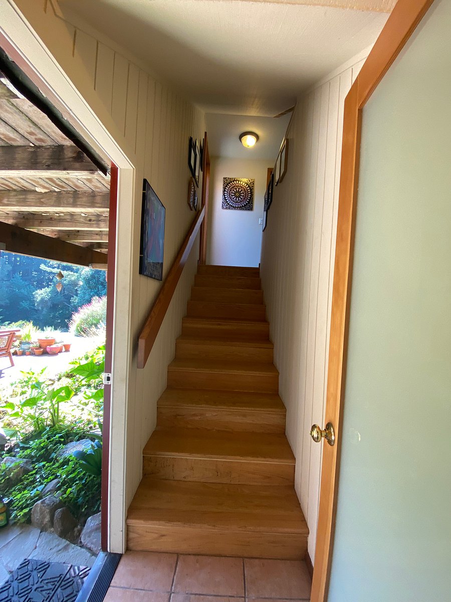 Hallway stairs leads up to shared kitchen.