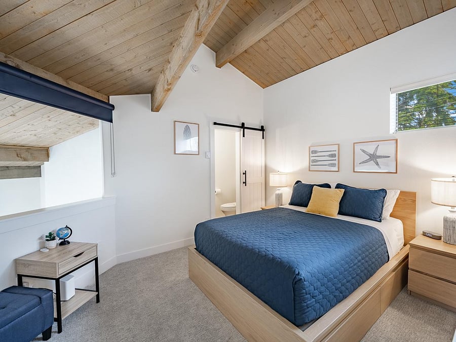Cozy upstairs bedroom retreat with vaulted ceilings and modern charm