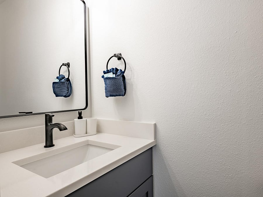 Sleek half bathroom vanity upstairs with modern fixtures and clean design