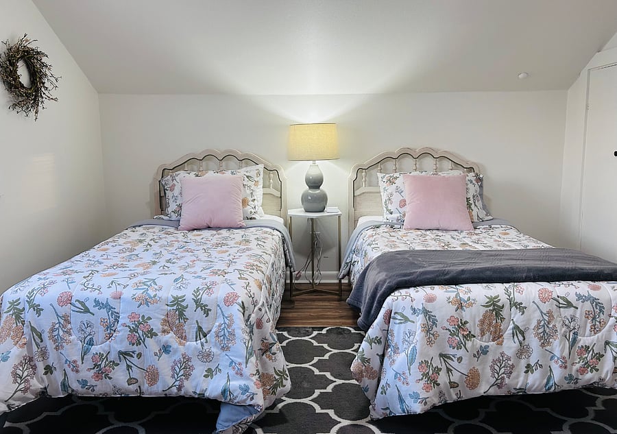 Upstairs bedroom with two twin beds, and a closet.