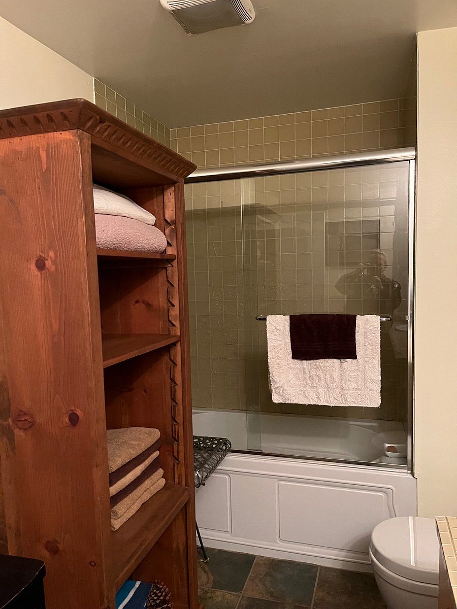 Heavy glass door enclosed shower/bath.