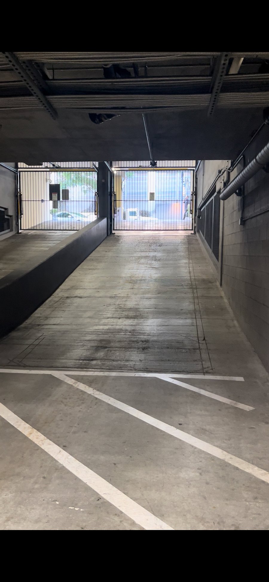 Gated entrance to underground garage.