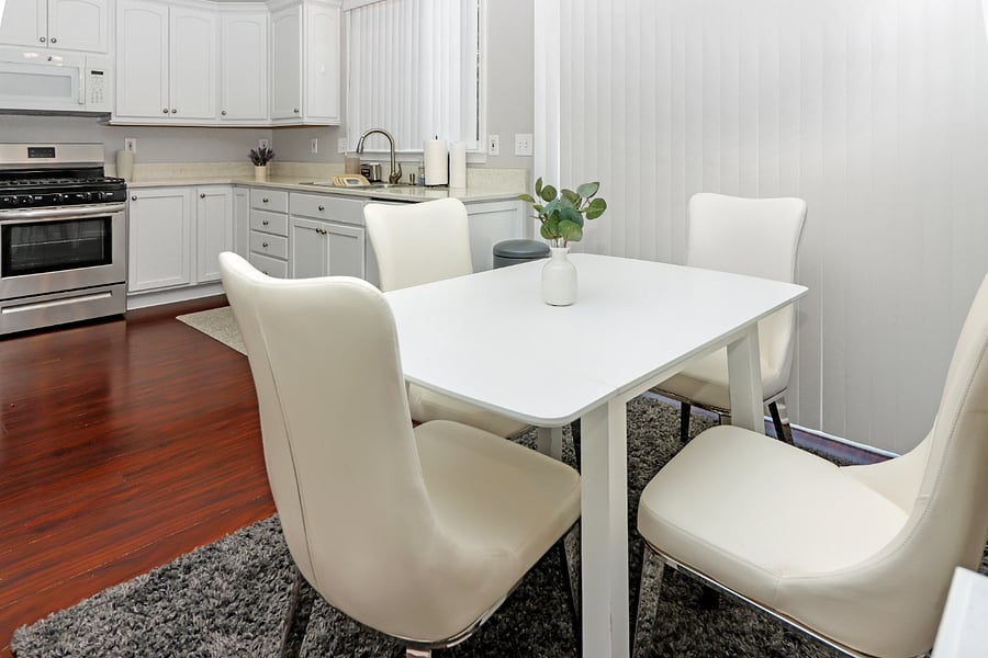 Gather in this cozy dining area, with warm wood floors and a welcoming vibe thats perfect for shared meals and good conversation."