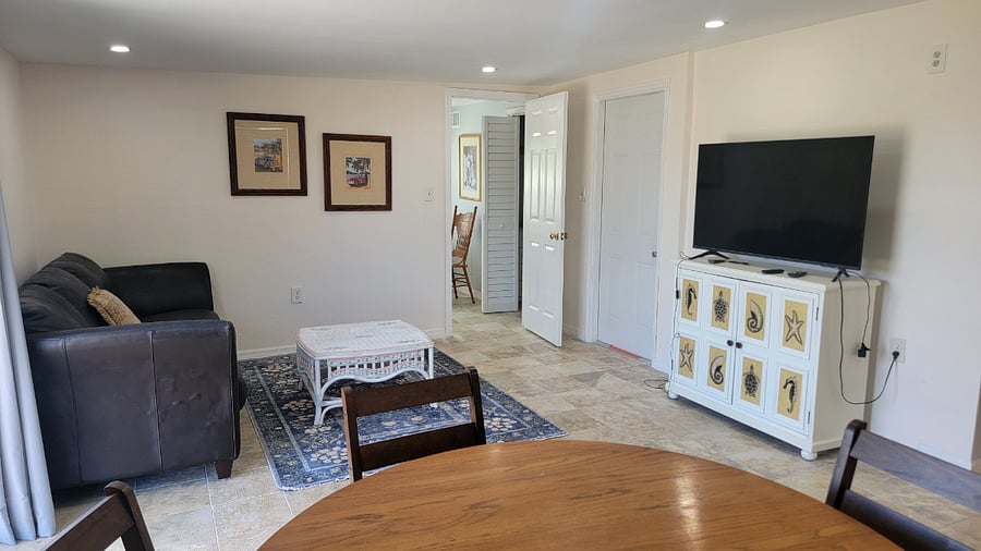 Family room with TV and large couch. Eating are and good place to play a game.