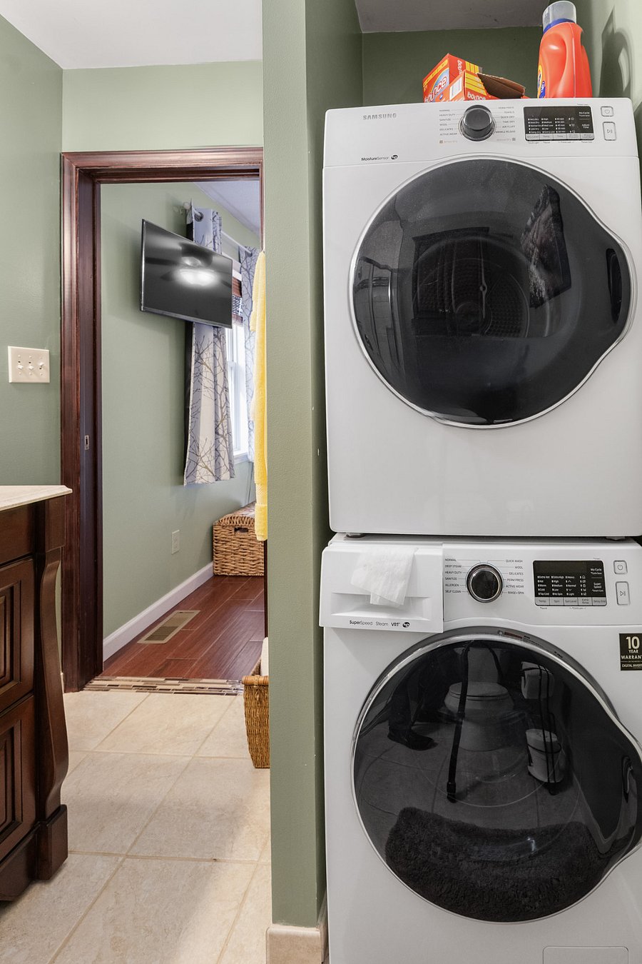 Primary bathroom features standing shower, washer, and dryer.