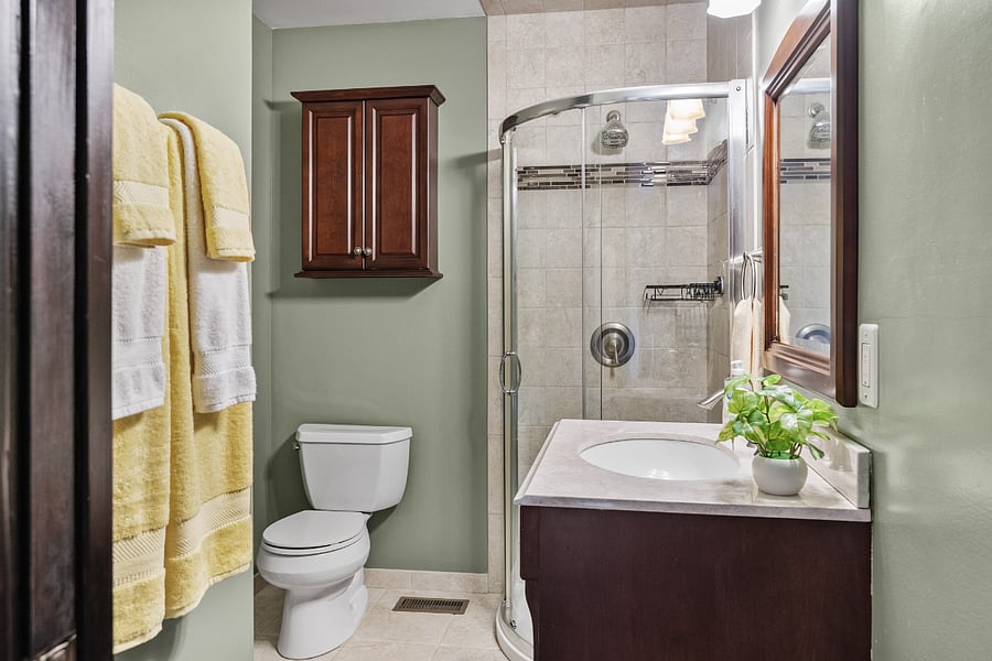 Primary bathroom features standing shower, washer, and dryer.
