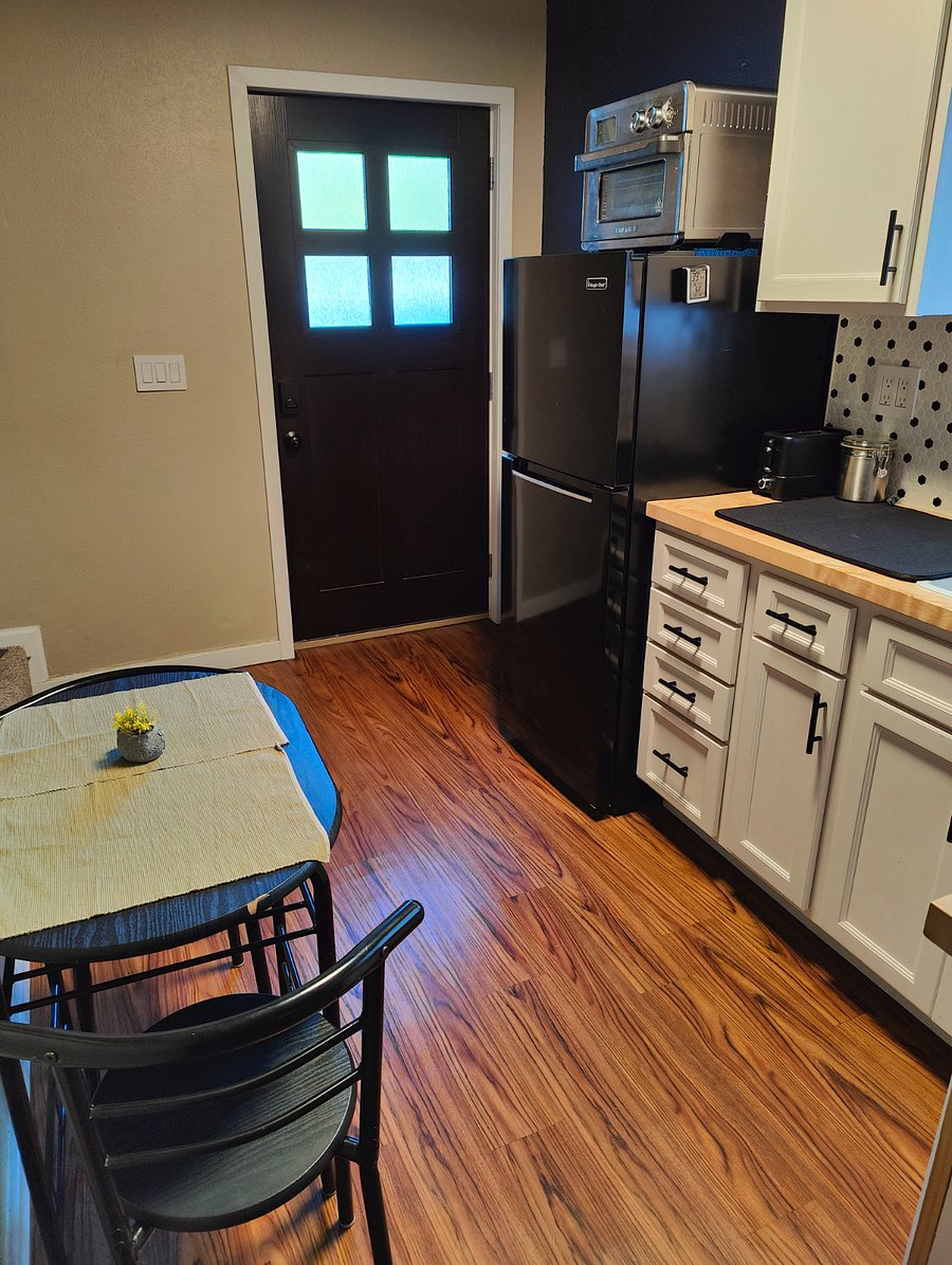 Kitchenette facing front door - stove top, microwave, toaster oven, and washer/dryer combo unit
