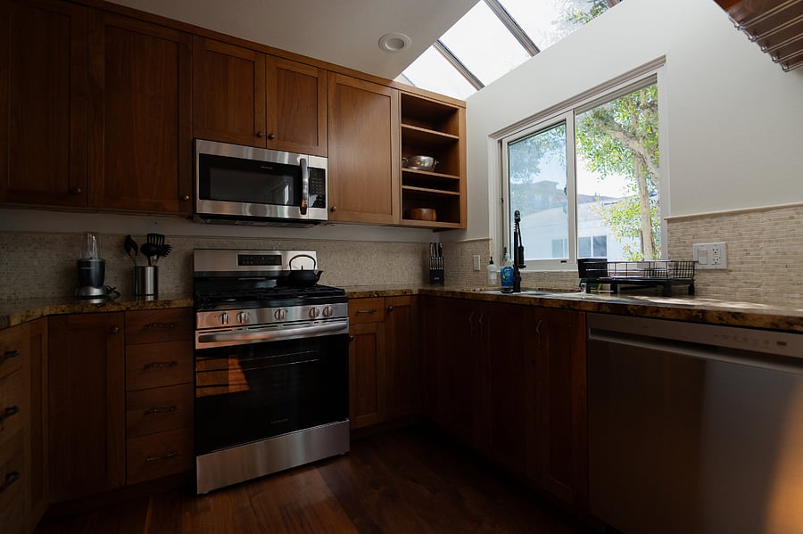 Full kitchen with brand new stainless steel appliances.  Natural sunlight from the windows and skylight above 