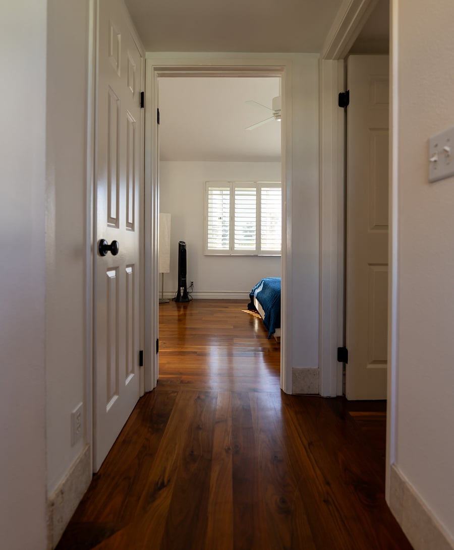 Upstairs hallway leading to primary suite and guest bedroom