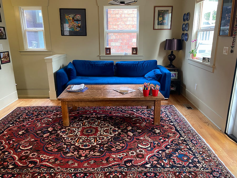 Couch in kitchen opposite the stove