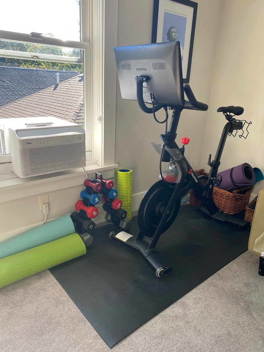 Peloton with free weights and yoga mats, plenty of space to yoga / lift in master