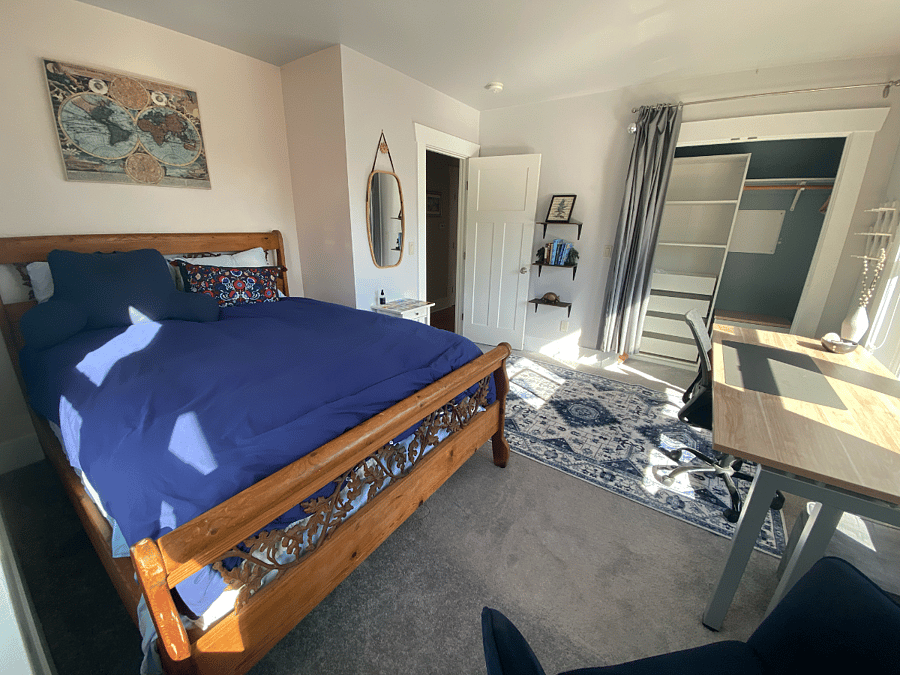 2nd bedroom with Queen bed, large windows overlooking the park across the street