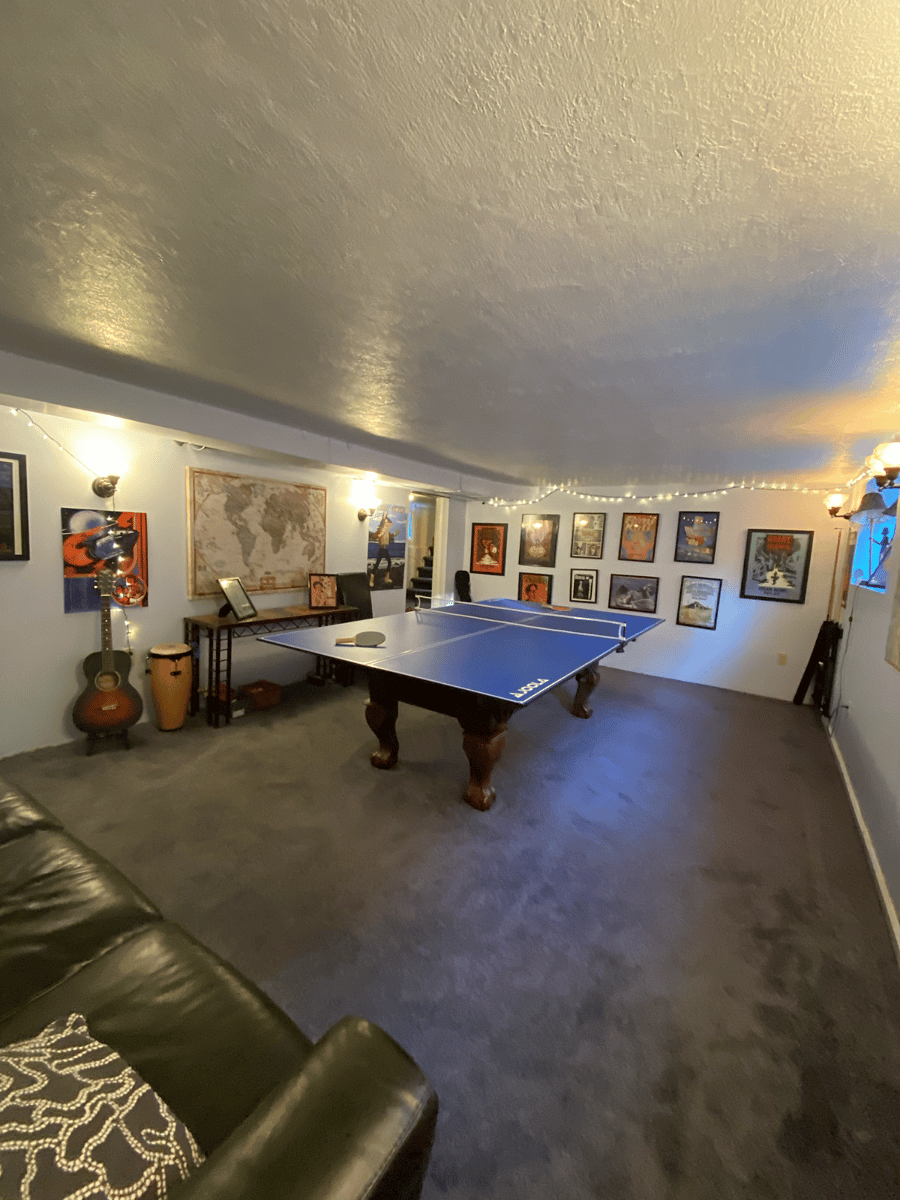 Basement game room, convertible ping pong / pool table. Couch and chairs for gaming