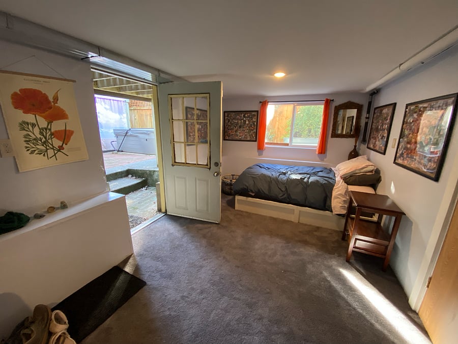 Extra guest bed in basement TV room, entrance to backyard and hot tub