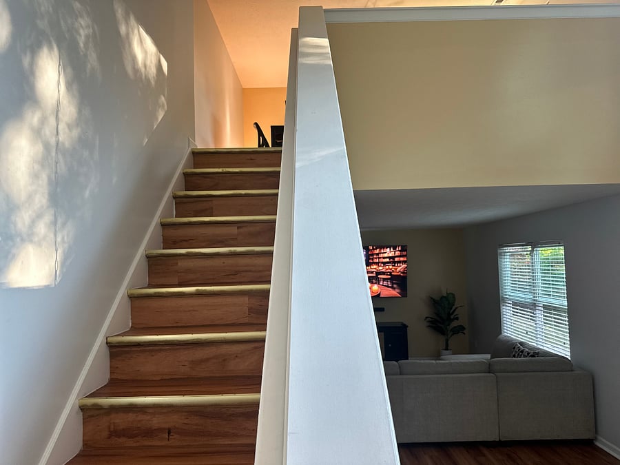 Take the stairs that guide you to your serene bedroom retreata welcoming pathtorelaxation.