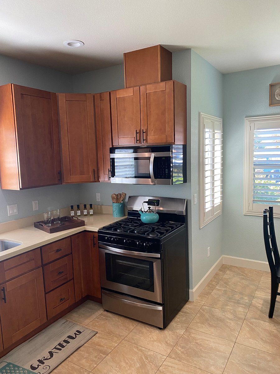 Stainless steel gas oven with overhead microwave, fully stocked kitchen with Keurig coffee maker