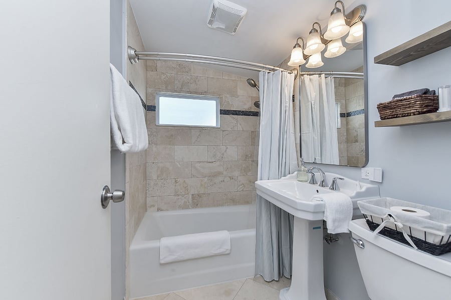 This bathroom, features shower/tub combo, fully stocked with fresh towels, shampoo, body wash, and conditioner for guest convenience.  