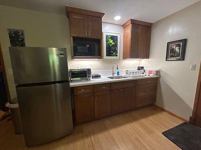 Kitchenette with full refrigerator.