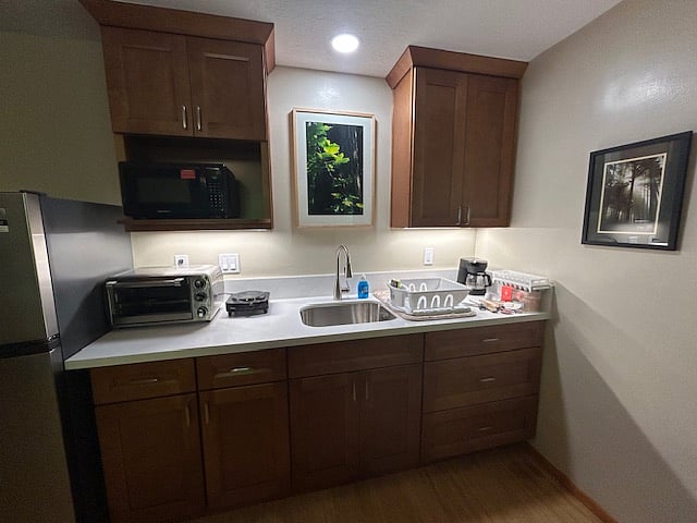 Kitchenette with quartz countertops, toaster oven, microwave, hotplate.
