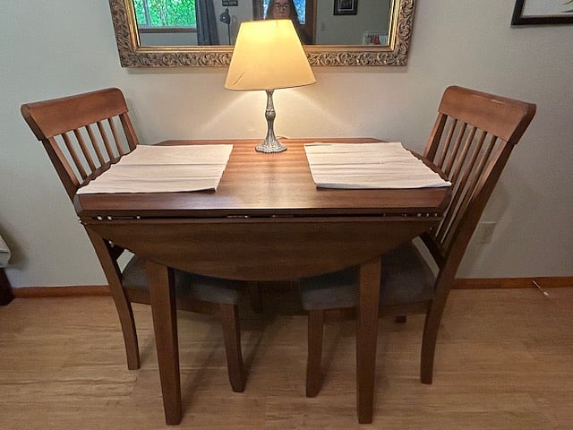 Wooden dining table with two chairs.