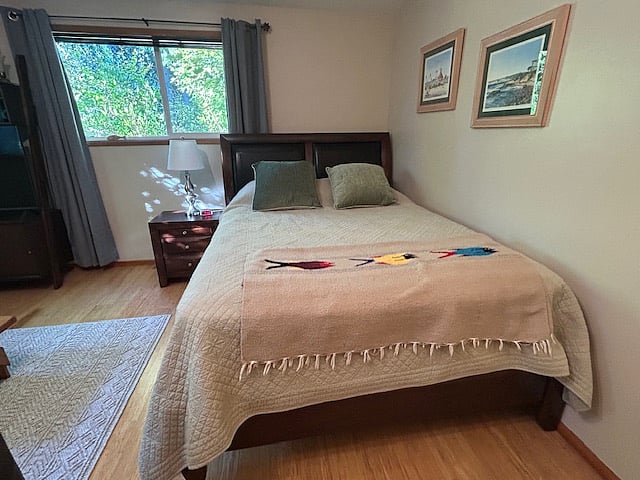 Comfortable queen-size bed with nightstand.