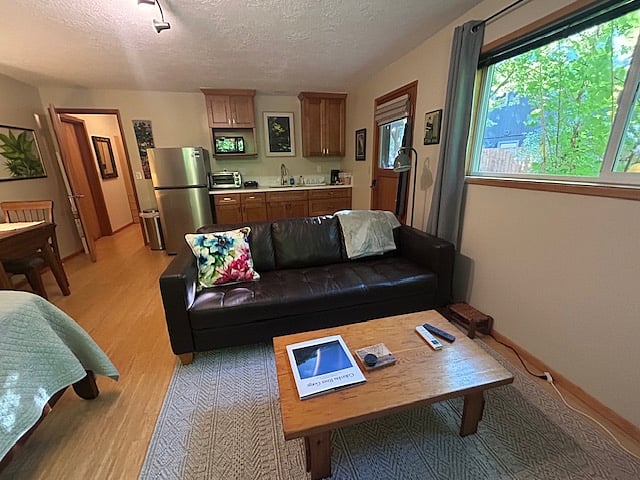 View of room looking towards kitchenette.  Private entrance door is on the right.  The door on the left leads into the closet room and the bathroom.