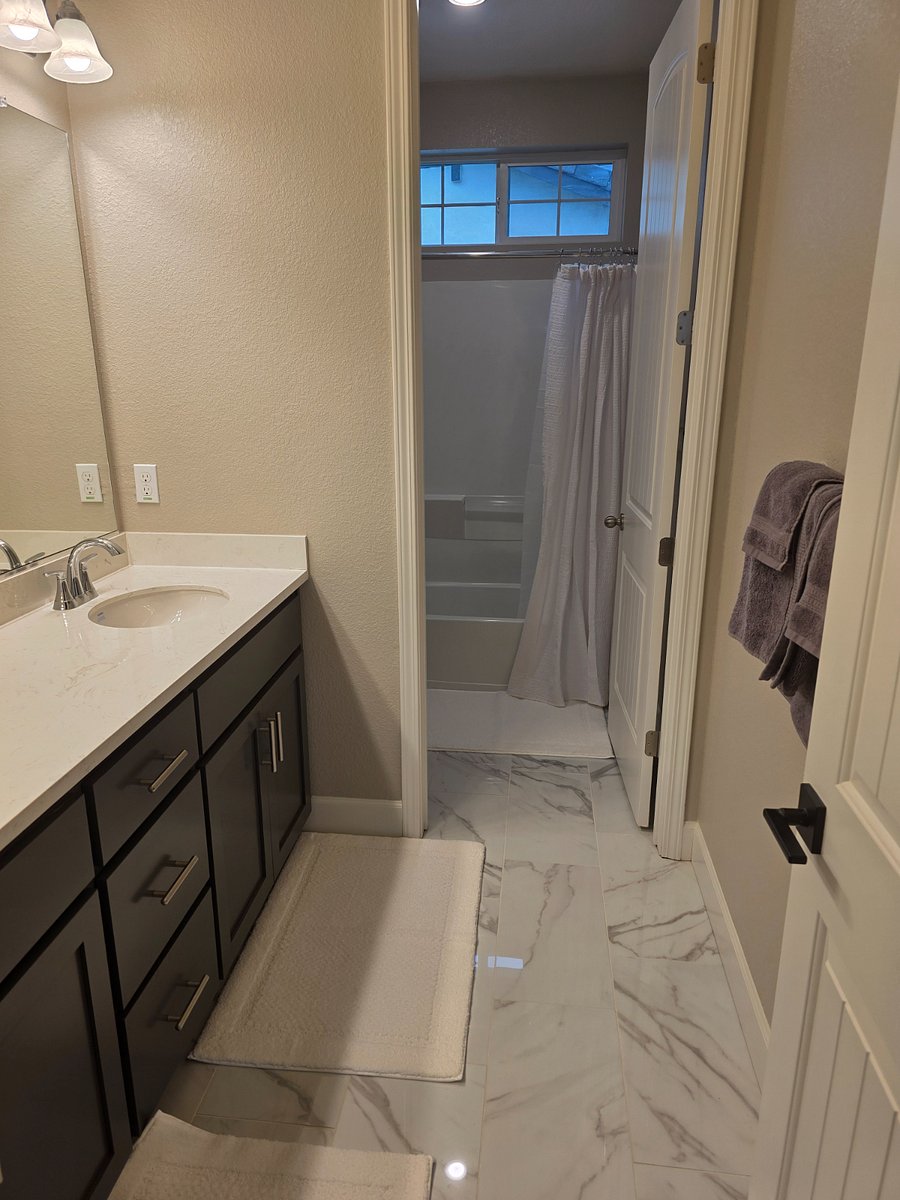Large bathroom on the second level, with two sinks and a ton of storage space.